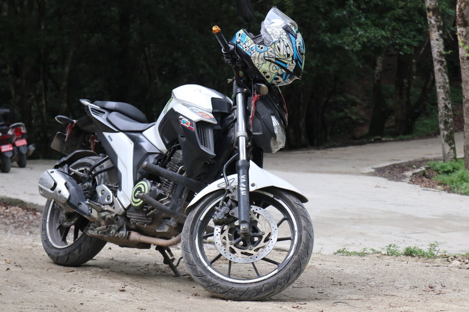 Motorcycle parked on a forest gravel road